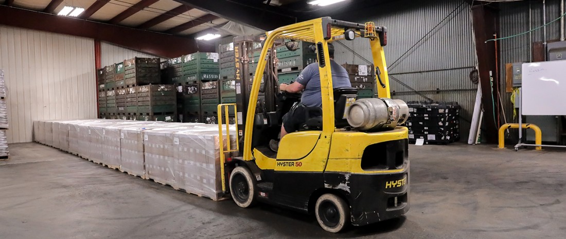 Forklift moving through Michigan warehouse, offering flexible cross docking and warehouse solutions.